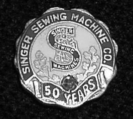 Singer's Fifty-Year employee service badge.