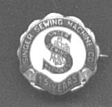 The badge that Singer Sewing Machine Company Employees received for ten or fifteen years of service with the company.