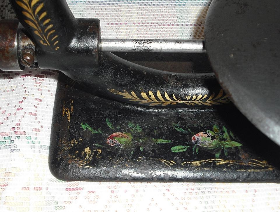 The ‘Queen’s Elliptic’ chainstitch machine, the hand painted rosebuds on the base (DA)