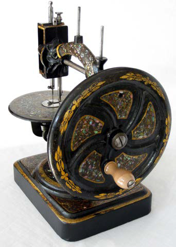 The Byron Sewing Machine - a mother-of-pearl version of the Little Stranger showing the solid handwheel